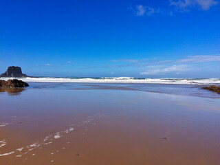 A sandy beach under a clear blue sky.