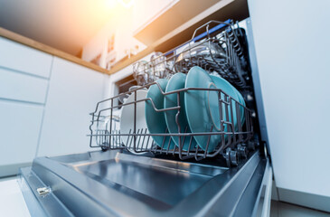 The white kitchen and opened dishwasher with clean dishes - obrazy, fototapety, plakaty