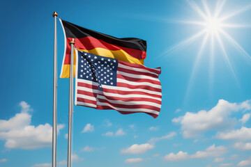 USA und BRD Flagge vor blauem Himmel im Wind als Hintergrund