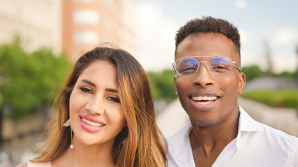 Multiethnic couple looking at the camera and smiling