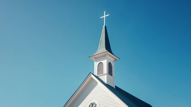 White Wooden Church Steeple with Classic Cross against a Vibrant Blue Sky: Symmetrical Architectural Stock Photography.