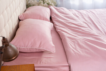 wrinkled pink cotton bed linen pillows morning messy