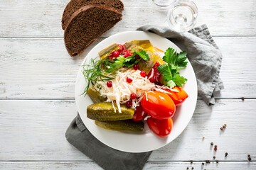 sauerkraut cucumbers and tomatoes food top view on white board