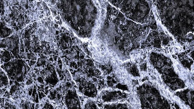 Vue &agrave; d&eacute;filement horizontal d'un mur en marbre noir avec effet bleu subtil nuanc&eacute; 