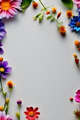 A background with different tiny colorful flowers on borders and blank space in centre for writing text 