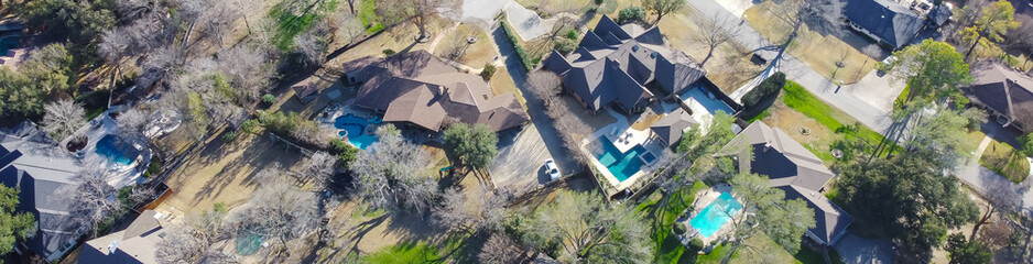 Panorama aerial view upscale two story house with circular driveway, swimming pool, large backyard,...