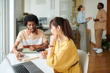 UI designer and front end developer discussing website interface