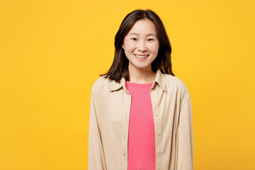 Young smiling happy satisfied cheerful fun cool woman of Asian ethnicity she wearing pink t-shirt...