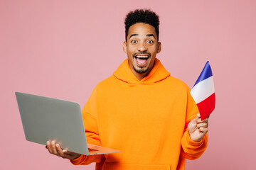 Young surprised IT man African American ethnicity he wear yellow hoody casual clothes hold French...
