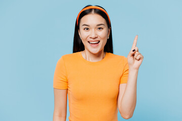 Young proactive woman of Asian ethnicity wear orange t-shirt casual clothes holding index finger up...