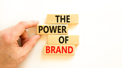 The power of brand symbol. Concept words The power of brand on beautiful wooden block. Beautiful white table white background. Businessman hand. Business the power of brand concept. Copy space.