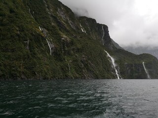 Fiordland National park with stunning views over the mountains covered with clouds.