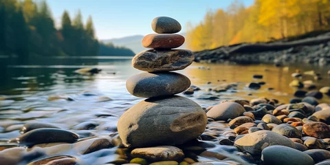Gordijnen A serene pile of smoothly rounded balanced stones by a river, capturing a peaceful and meditative atmosphere during sunset © YasumiHouse
