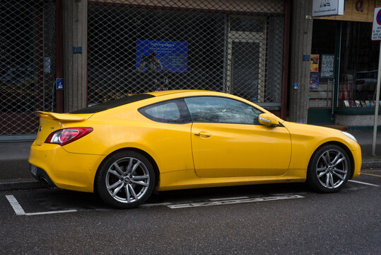 Mulhouse - France - 25 february 2024 - Profile view of yellow hyundai coupe parked in the street