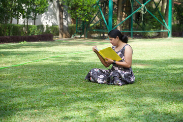 Fototapeta premium happy woman reading book outdoors