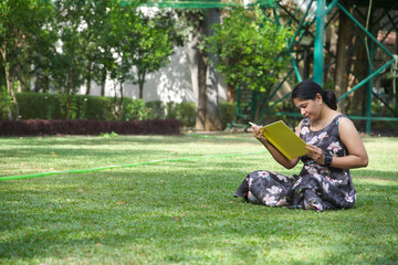 happy woman reading book outdoors