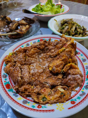 Talua Barendo, or Lacy Omelet, is a special fried crispy egg at Nasi Kapau restaurant in West Sumatra. Indonesian traditional food. Delicious fried chicken and Ikan Bilih