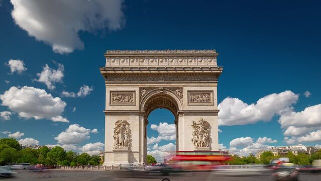 PARIS, FRANCE - FEBRUARY 20, 2024: Timelapse motion hyperlapse view of the Arc de Triomphe (Triumphal Arch of the Star) with traffic on circle road. Famous monument and touristic landmark in Paris.