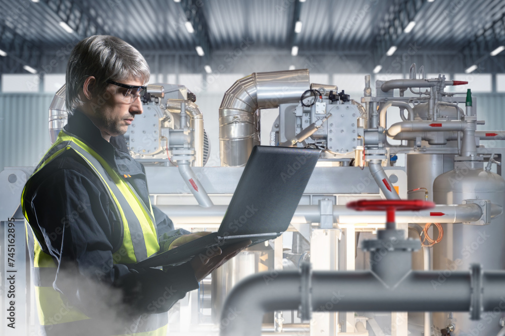 Poster man is industrialist. factory worker with laptop. engineer is standing in industrial building. man f