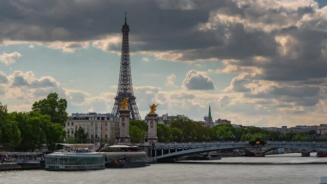 PARIS, FRANCE - FEBRUARY 20, 2024: Timelapse motion hyperlapse view of the Eiffel Tower and Champ de Mars on embankment of the Seine River, famous touristic landmark.
