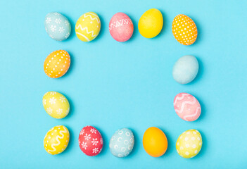 Easter eggs on a bright blue background. Easter celebration concept. Colorful easter handmade decorated Easter eggs. Place for text. Copy space.