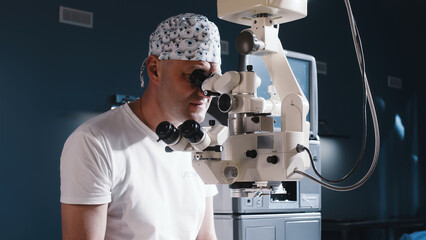 A male doctor performs a high-precision operation. Femtolaser cataract surgery. An ophthalmic...