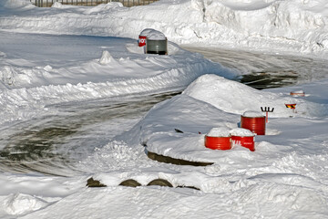 A fragment of a snow-covered go-kart track on a winter day
