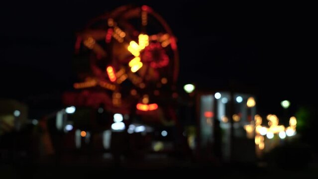 defocused abstract background of wheel and colorful lights at night