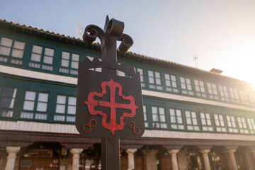 Old Iron Emblem of the Order of Calatrava iluminated by the morning sun. red Greek cross with...