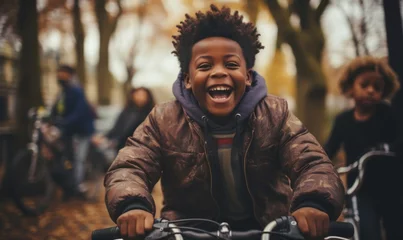 Foto op Canvas Portrait of an happy african american boy on a bicycle in the park. Paris © PanArt