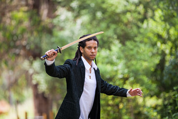 Brazilian individual with rastas, holding a samurai sword