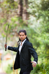 Brazilian individual with rastas, holding a samurai sword - 745180892