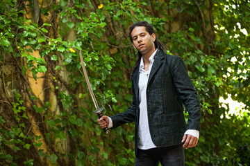 Brazilian individual with rastas, holding a samurai sword