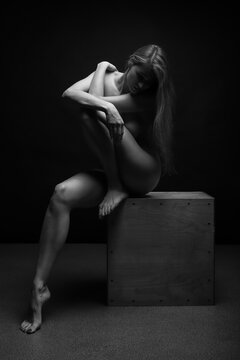Athletic Naked woman body on grey background. Fine art photo of female body.