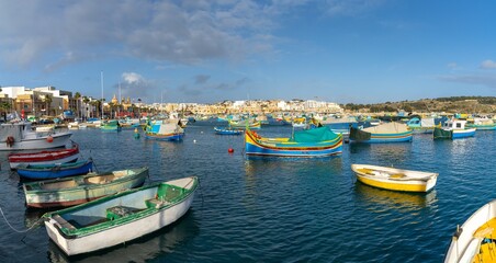 Fototapeta na wymiar colorful fishing boats in the harbor of Marsaxlokk in southeastern Malta