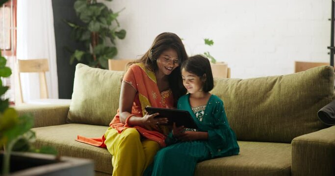 Mom, child and high five with tablet in home living room for progress, e learning and success for online course. Education, mother and daughter girl with digital touchscreen in Indian family house