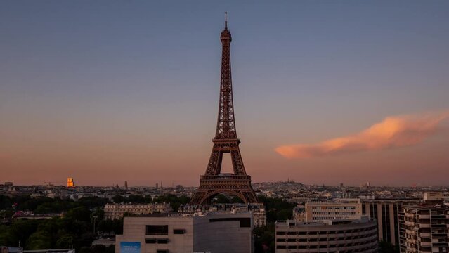 PARIS, FRANCE - FEBRUARY 20, 2024 : Timelapse motion hyperlapse view of the Eiffel Tower and Champ de Mars, famous touristic landmark.
