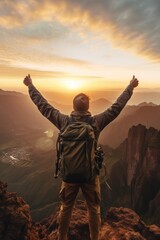 A man standing triumphantly with arms raised on a mountain top. Perfect for outdoor adventure concepts - obrazy, fototapety, plakaty