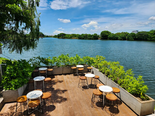 Coffee shop benches with blue water and a blue sky background in West Jakarta