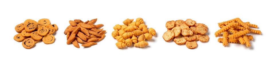 Heap of different traditional Moroccan Krichlate spicy miniature shortbread cookies isolated on white background close up
