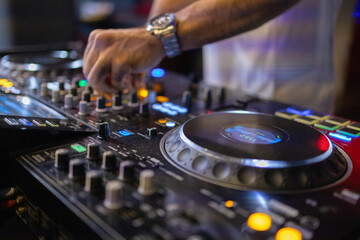 Fototapeta na wymiar DJ's Hands Adjusting Music Mixer at Event