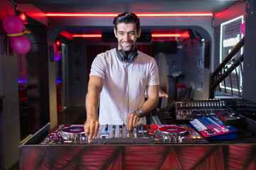 Focused DJ Crafting Mix at Neon-Lit Club