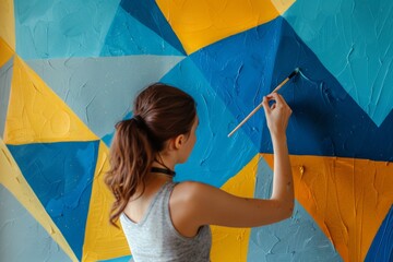 Woman Painting Geometric Patterns on a Wall in Her Home