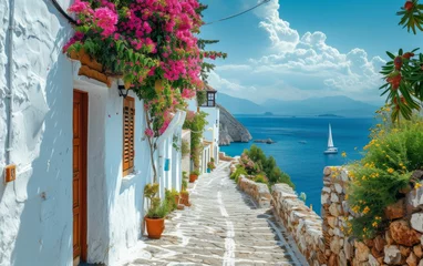 Fotobehang A narrow street lined with colorful flowers leads to a picturesque sailboat floating on the water © imagineRbc