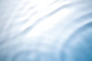 The clear blue surface of the water gradients from light to dark.