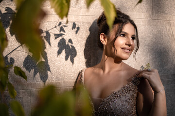 Close up portrait of a teen brunette girl in a golden dress. Ready for prom