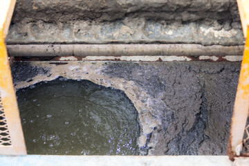 Dirty bubbles floating on waste-water surface water from factory or industrial activated sludge industrial wastewaters process sewage treatment plant. 