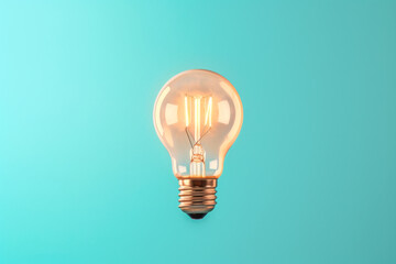 Capture brilliance with this high-resolution photo of a light bulb set against a vibrant blue background
