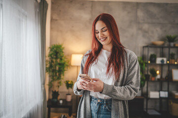 young woman at home use mobile phone sms texting or browse internet
