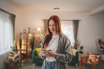 young woman at home use mobile phone sms texting or browse internet